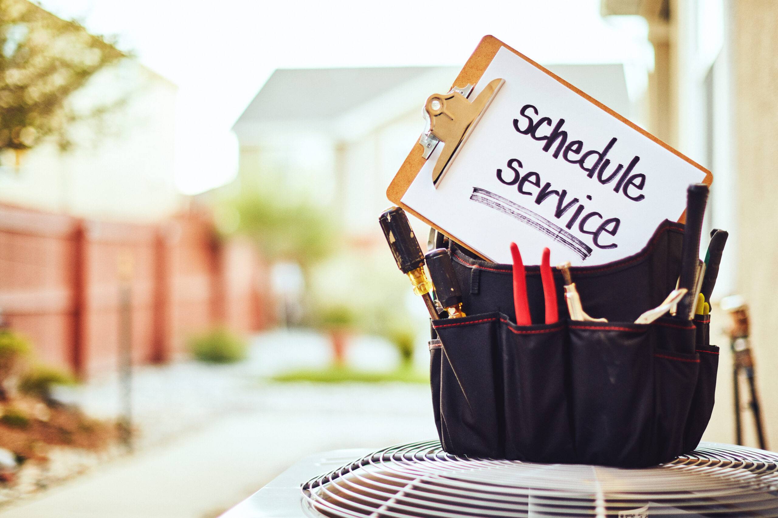 Air conditioner with maintenance tools and service reminder in residential back yard Chicago air conditioning repair HVAC