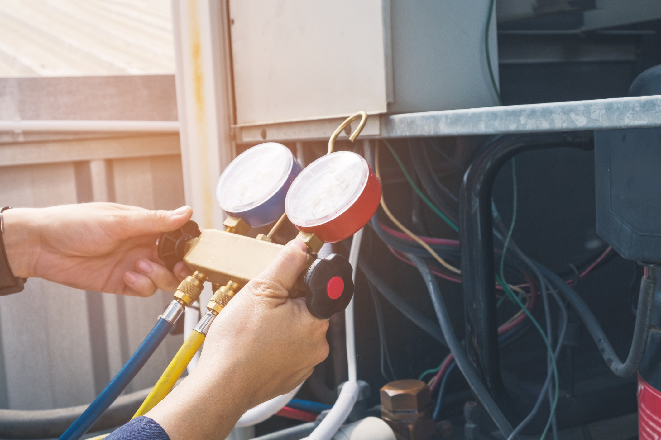 Technician is checking air conditioner Chicago air conditioning repair HVAC